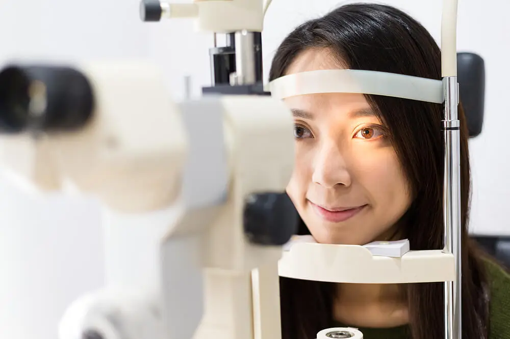 Eye specialist examining a patient during a pre-surgery cataract assessment